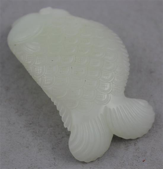 A Chinese white jade carving of dragon-fish, 8.5cm.